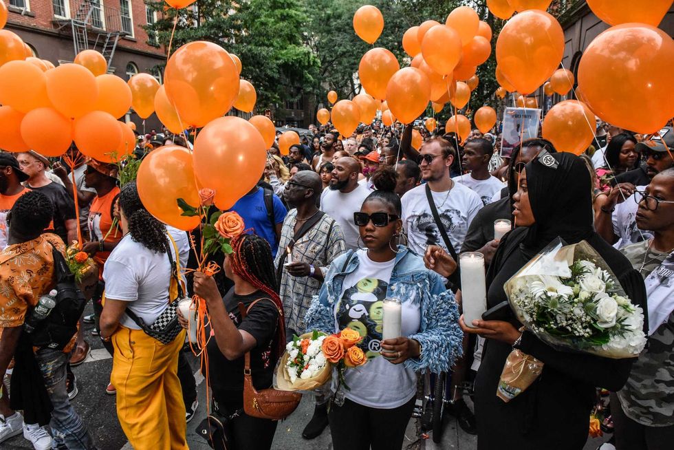 People participate in a memorial march for O