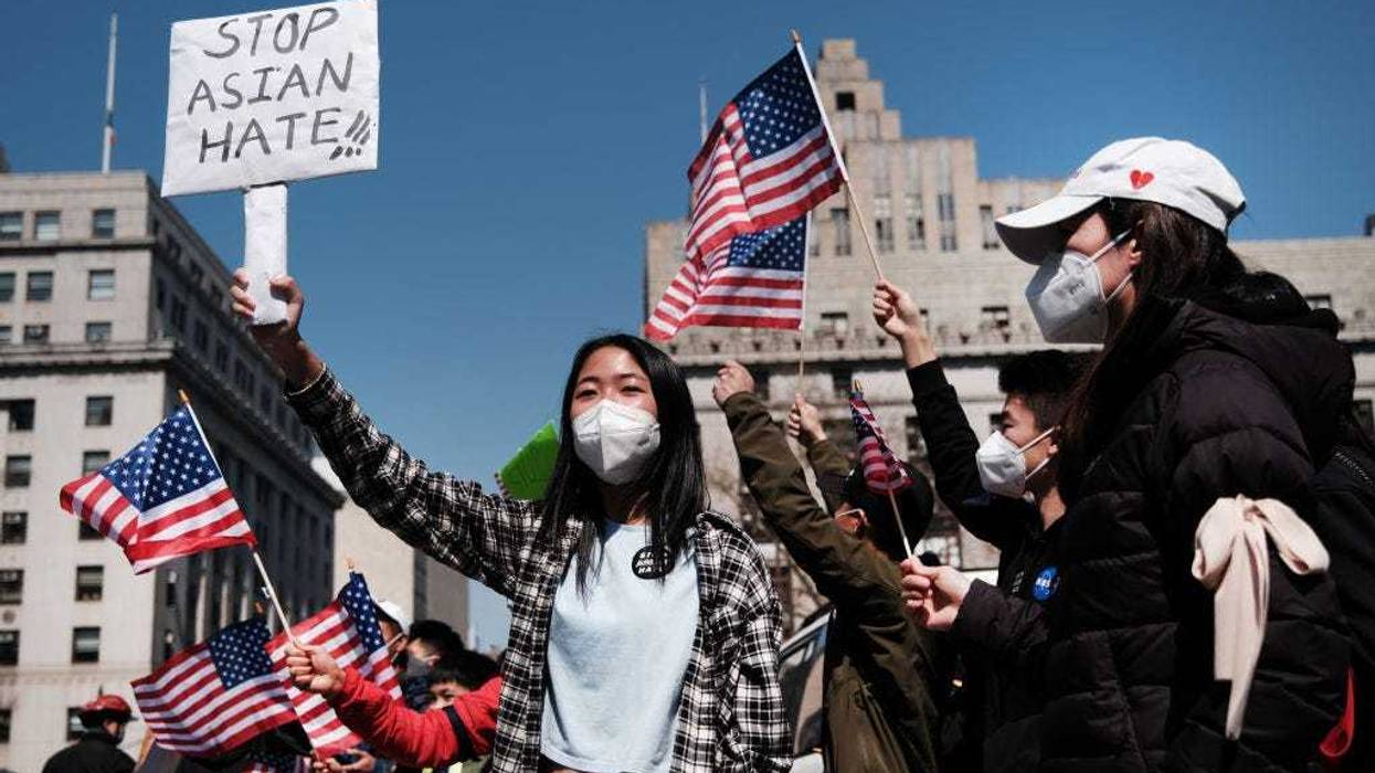 People participate in a protest to demand an end to anti-Asian violence on April 04, 2021 in New York City. The group, which numbered near 3000 and was made up of activists, residents and local politicians, marched across the Brooklyn Bridge. After a rise in hate crimes against Asians across the U.S. and in New York City, groups are speaking up and demanding more attention to the issue. (Photo by Spencer Platt/Getty Images)