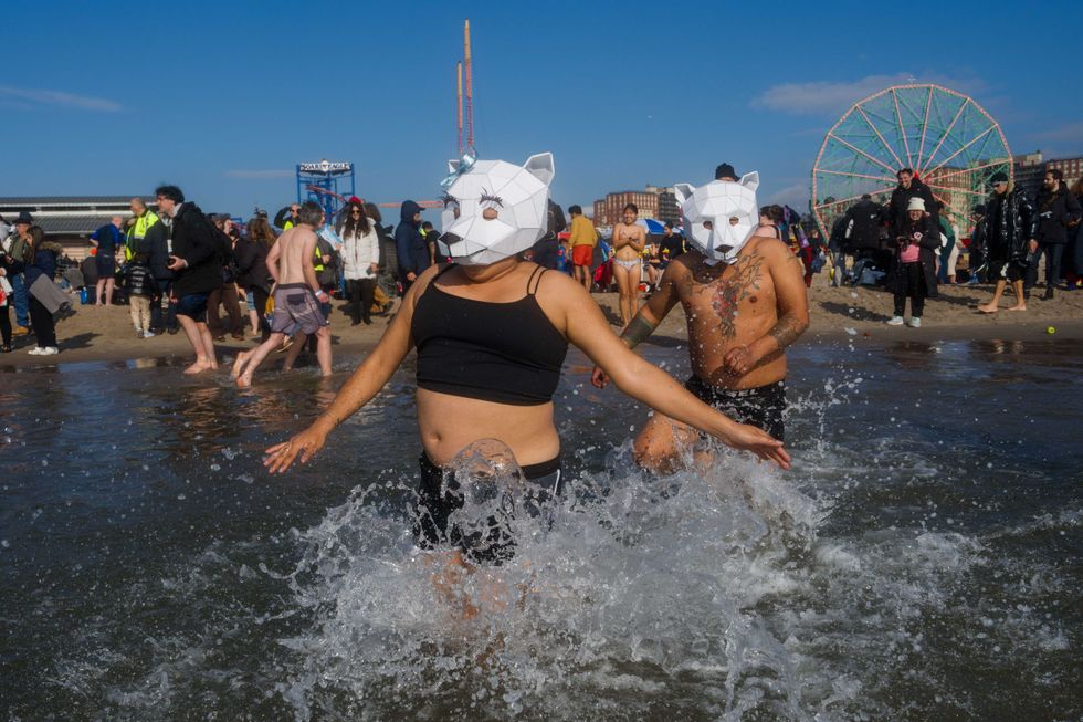 People participate in the 121st annual Polar Bear Plunge in Coney Island on January 1, 2024 in New York City.