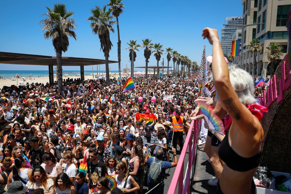 People participate in the annual Pride Parade, in Tel Aviv, Israel, Friday, June 25, 2021. Tens of thousands of people attended the parade on Friday in one of the largest public gatherings held in Israel since the onset of the coronavirus pandemic.