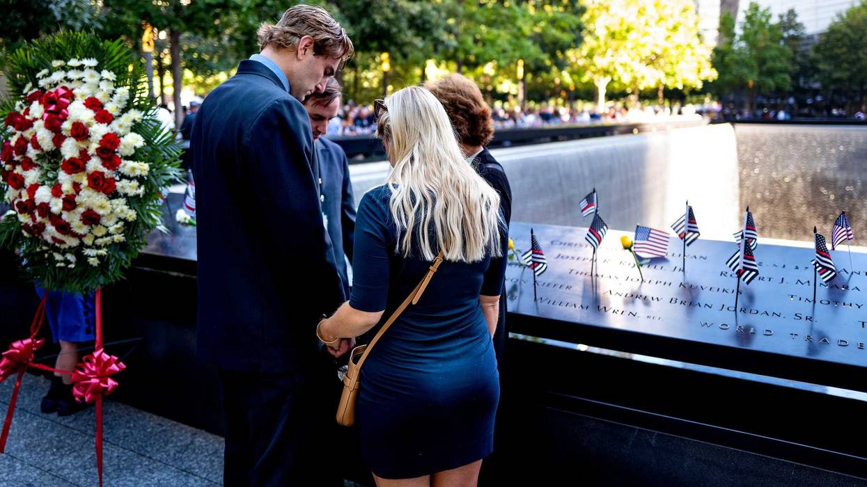 : People pause at 9:59 A.M., the moment 20 years ago the south tower of the World Trade Center fell, during a ceremony at the 9/11 Memorial and Museum on September 11, 2021 in New York City.