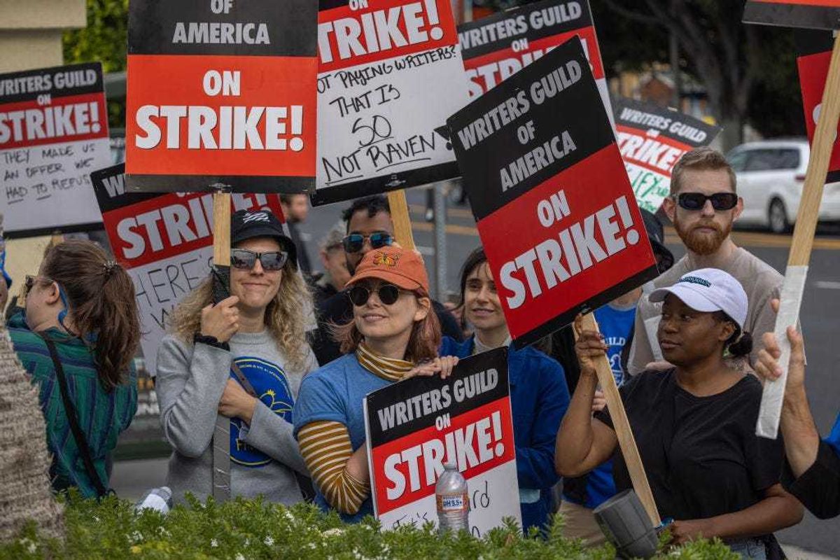 People picket outside of Paramount Pictures studios during the Hollywood writers strike on May 4, 2023 in Los Angeles, California. Scripted TV series, late-night talk shows, film and streaming productions are being interrupted by the Writers Guild of America (WGA) strike.