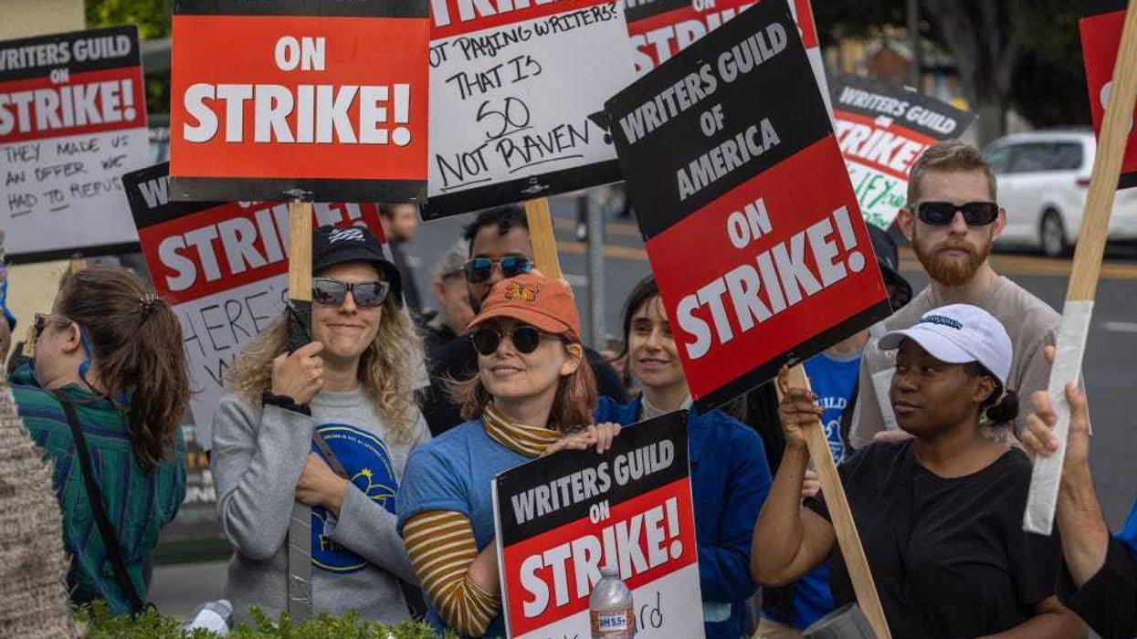 People picket outside of Paramount Pictures studios during the Hollywood writers strike on May 4, 2023 in Los Angeles, California. Scripted TV series, late-night talk shows, film and streaming productions are being interrupted by the Writers Guild of America (WGA) strike.
