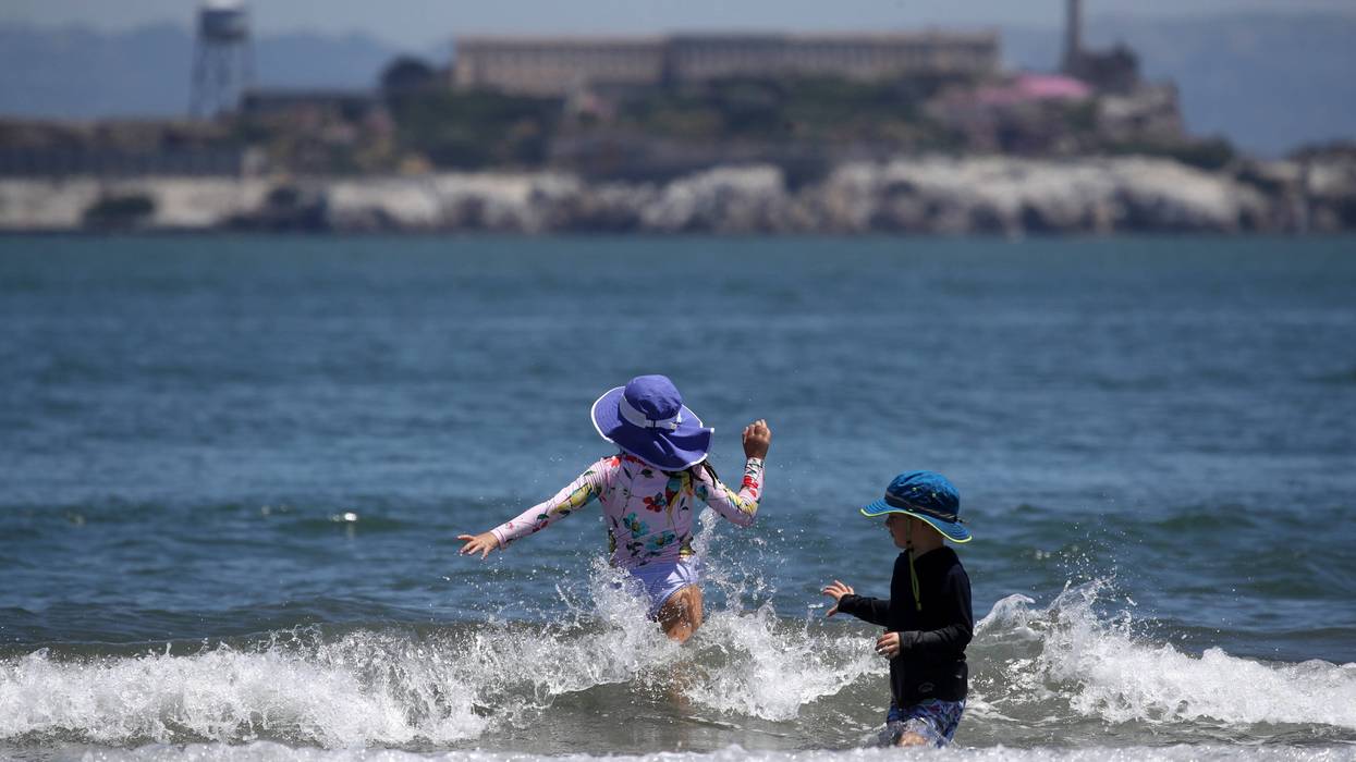 People play in the water at Crissy Field East Beach on June 11, 2019 in San Francisco, California.