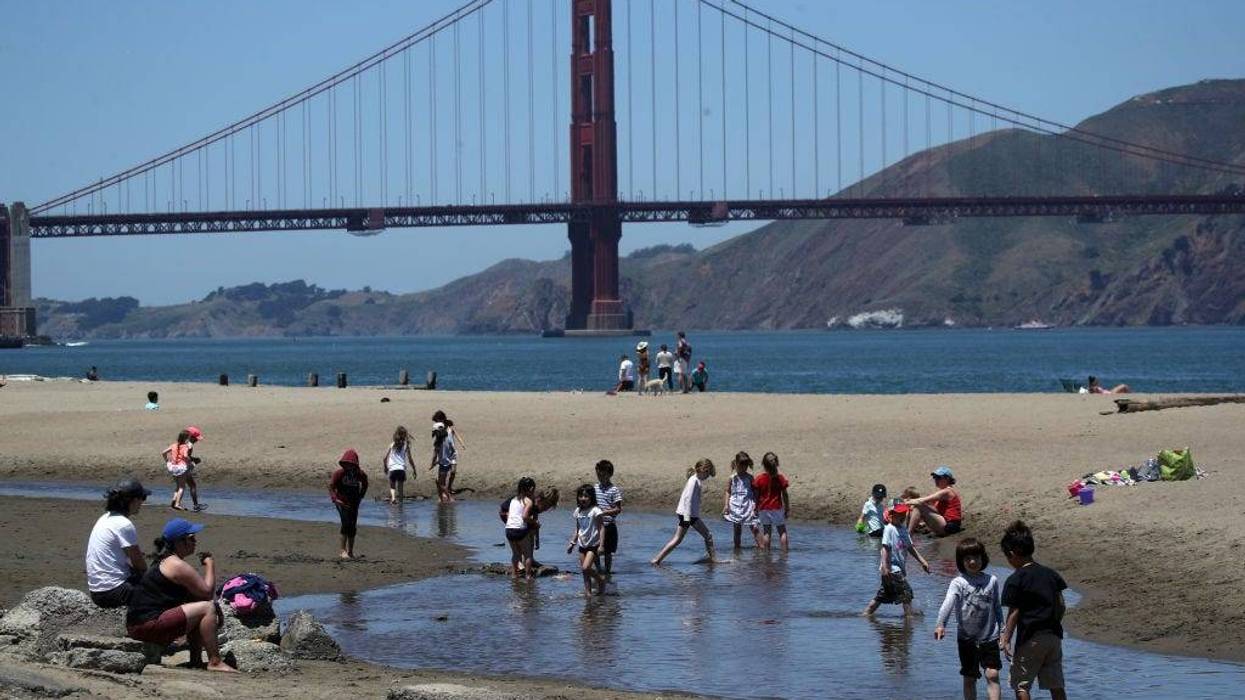 People play in the water at Crissy Field East Beach on June 11, 2019 in San Francisco, California.