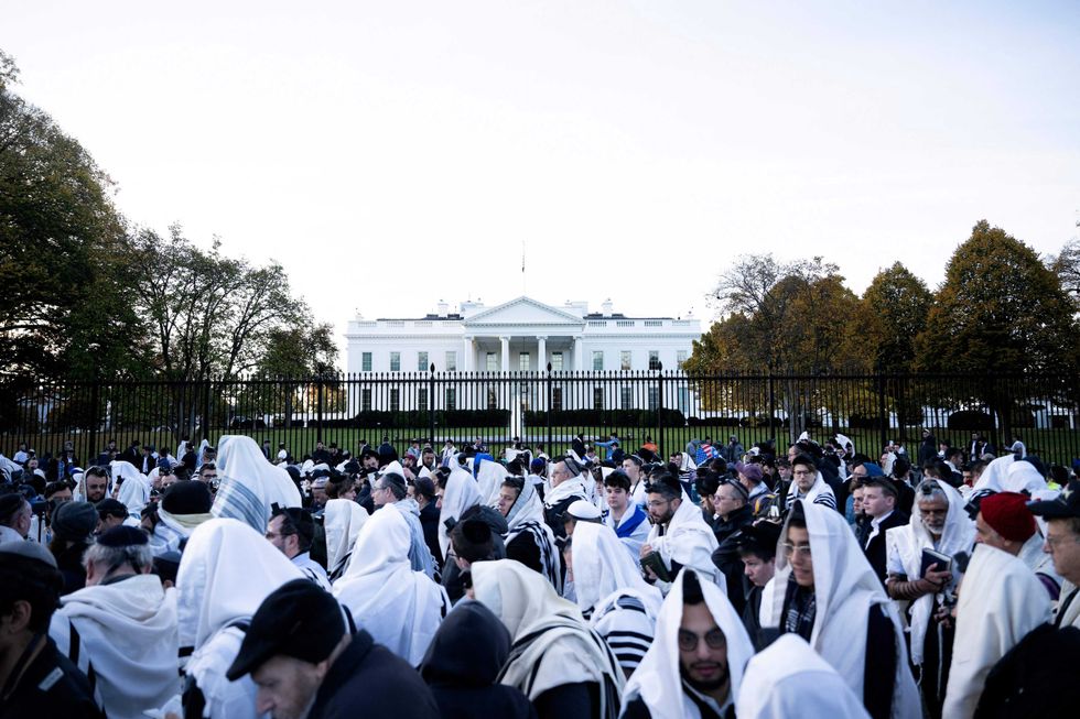 People pray on Pennsylvania Avenue in front of the White House before a rally supporting Israel during its conflict with Hamas November 14, 2023, in Washington, DC.