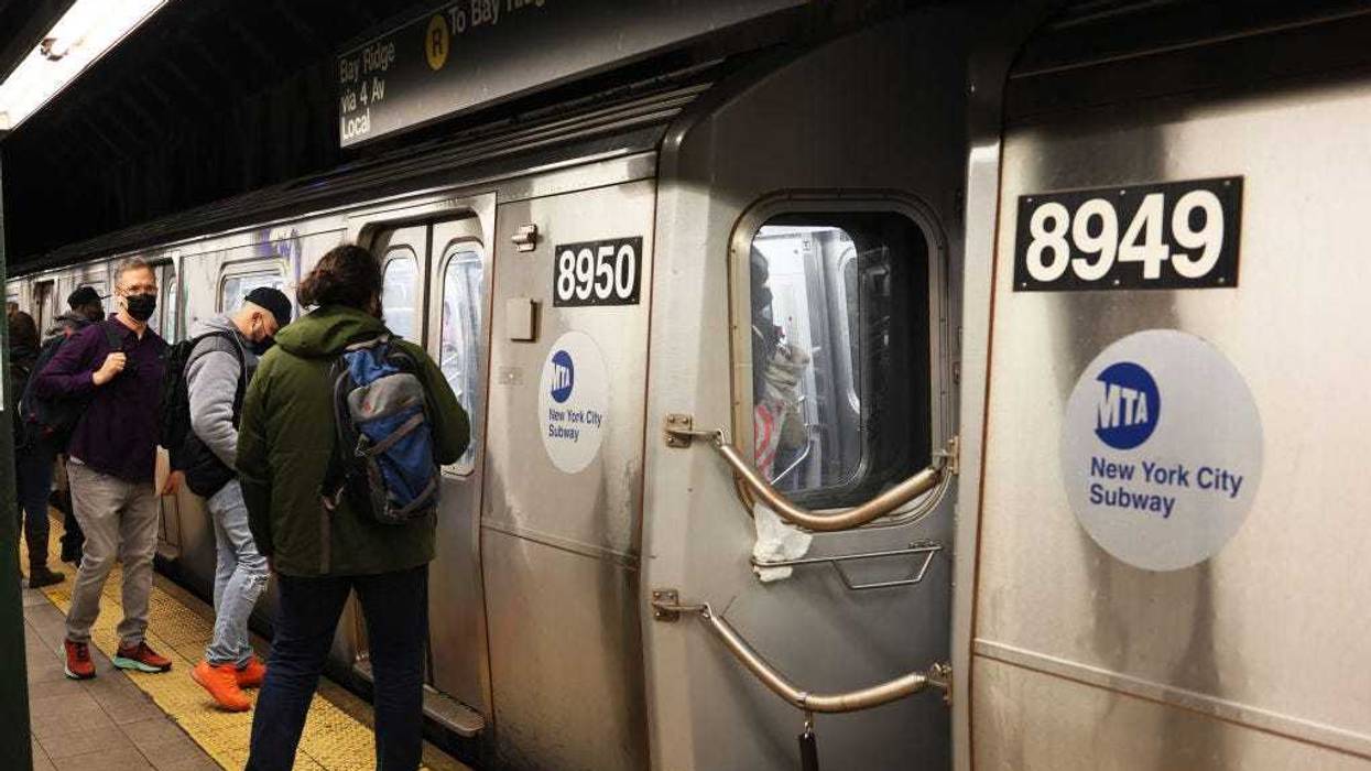 People prepare to enter the R train in Brooklyn on April 13, 2022.