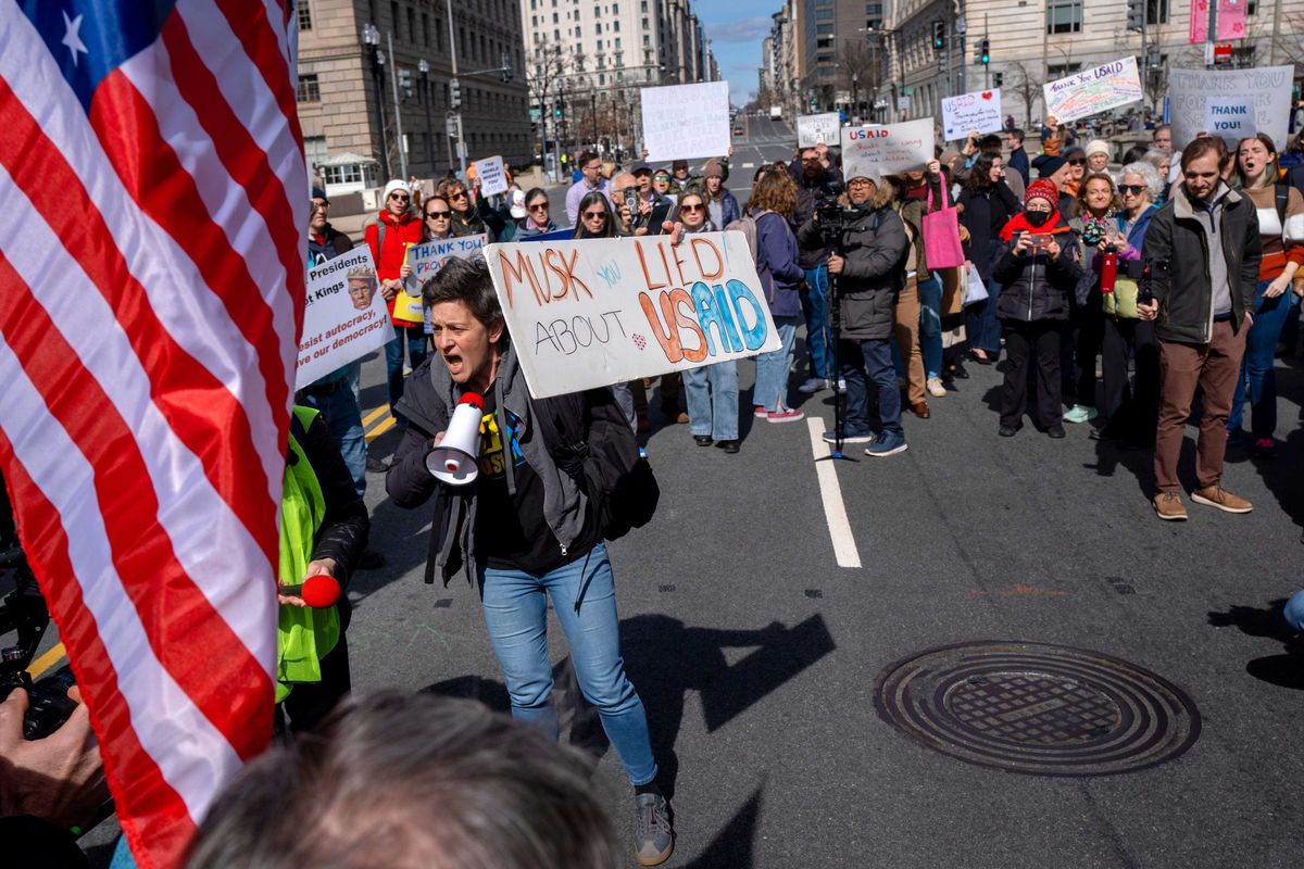 People rally on 14th St NW in support of fired USAID workers during a protest, Friday, Feb. 28, 2025, by the USAID headquarters in Washington.