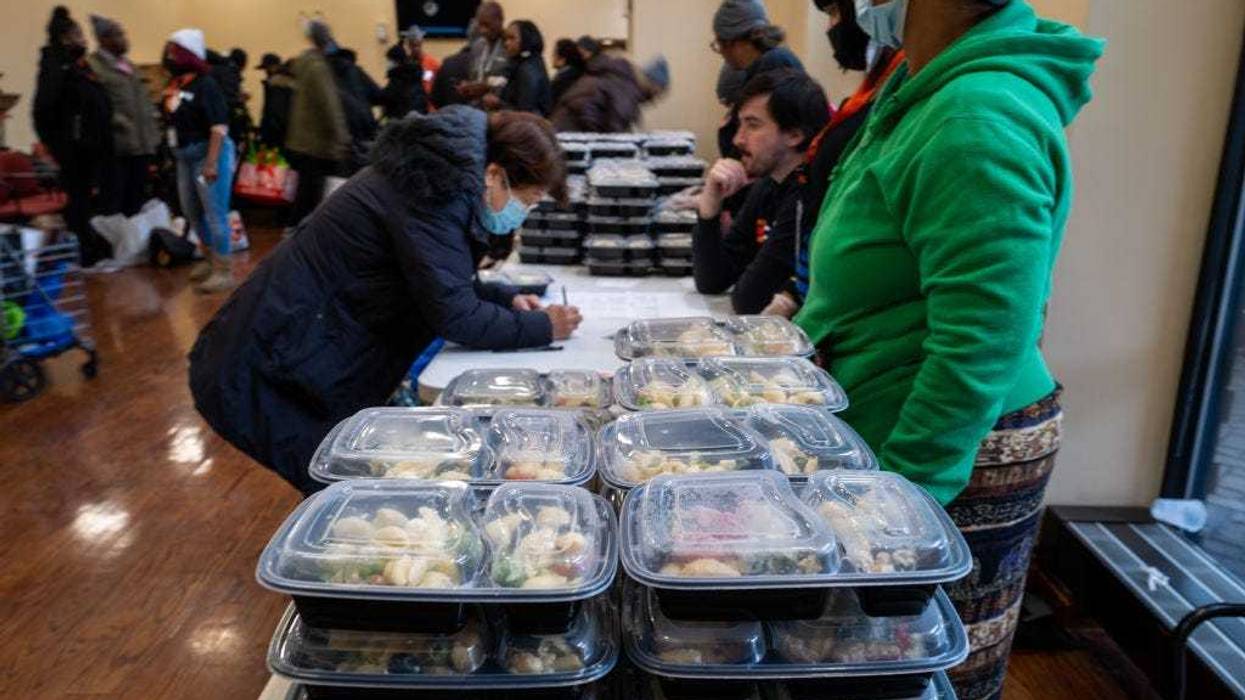 People receive free turkeys and other Thanksgiving oriented food at a community Thanksgiving food drive in Brooklyn to those in need on November 16, 2022 in New York City. The events, which was hosted by local politicians, businesses and charities, gave away over 1000 turkeys, chicken dinners and groceries. As food prices continue to rise across the country due to inflation, millions of Americans are struggling to afford groceries this holiday season.(Photo by Spencer Platt/Getty Images)