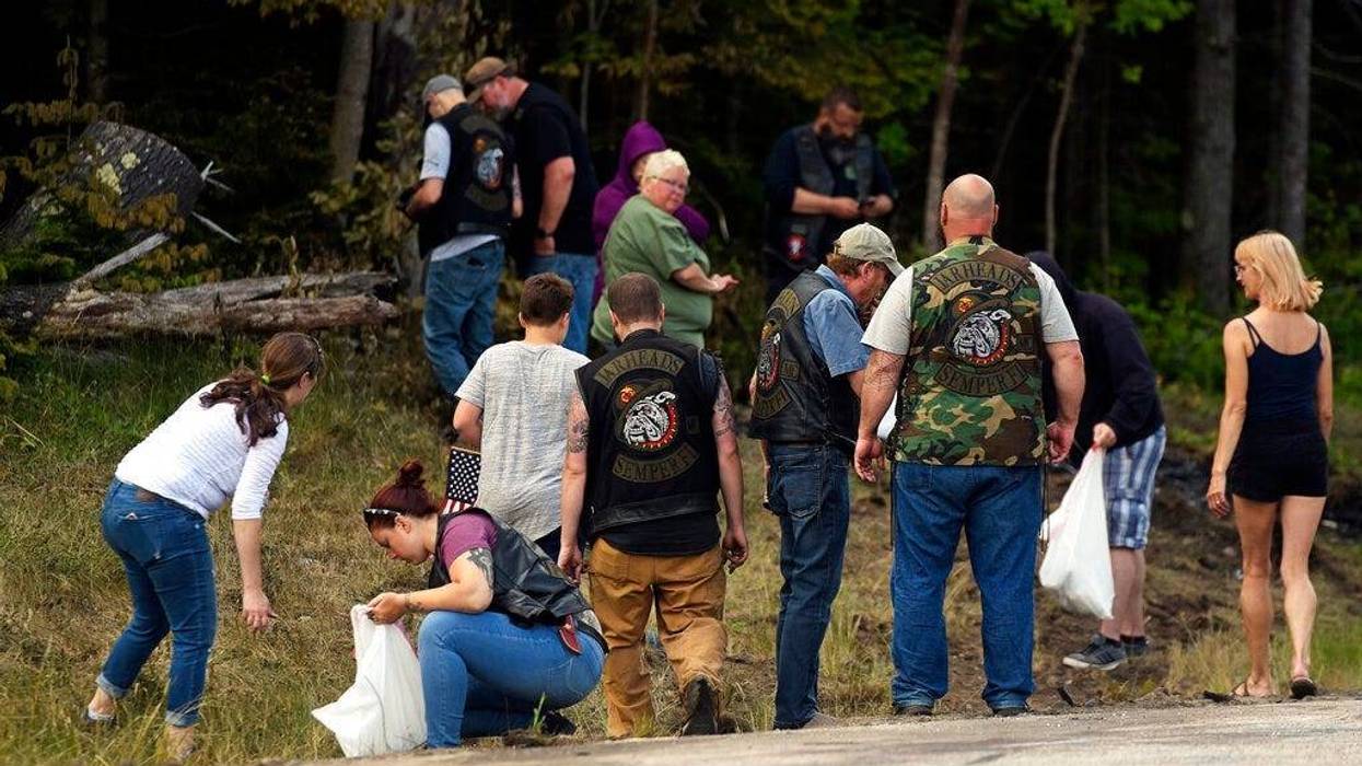 People recover personal items from the scene of a fatal accident on Route 2 in Randolph, N.H., Saturday, June 22, 2019. Investigators pleaded Saturday for members of the public to come forward with information that could help them determine why a pickup t