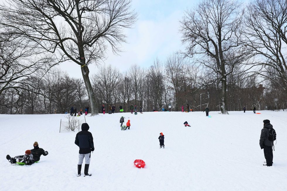 People ride sleds down a hill in Prospect Park in the Flatbush neighborhood of Brooklyn on December 17, 2020 in New York City.