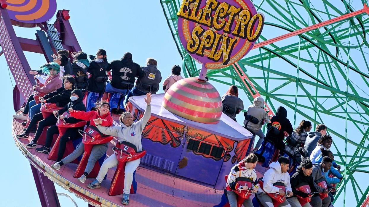 People ride the Electro Spin at Luna Park on the opening day of the season at Coney Island on April 2, 2022.