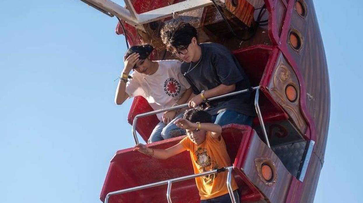 People riding a swing ship ride