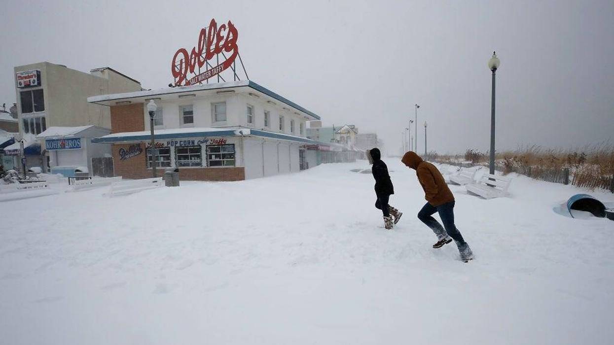 People run across the snow covered boardwalk, on January 4, 2018 in Rehoboth Beach, Delaware.
