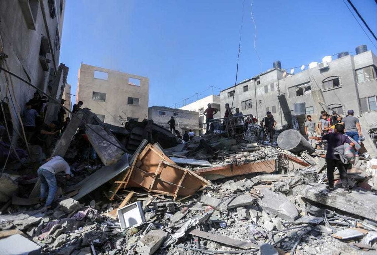 People search through buildings, destroyed during Israeli air raids in the southern Gaza Strip on November 6, 2023 in Khan Yunis, Gaza.