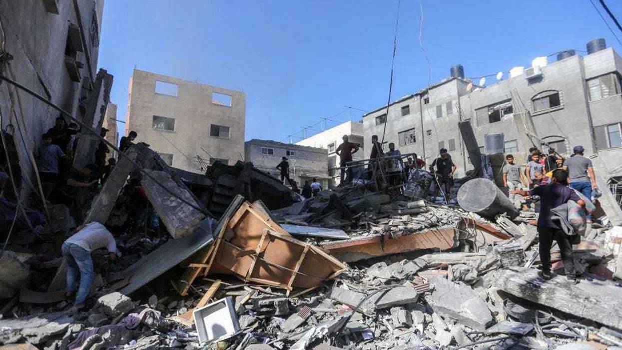 People search through buildings, destroyed during Israeli air raids in the southern Gaza Strip on November 6, 2023 in Khan Yunis, Gaza.