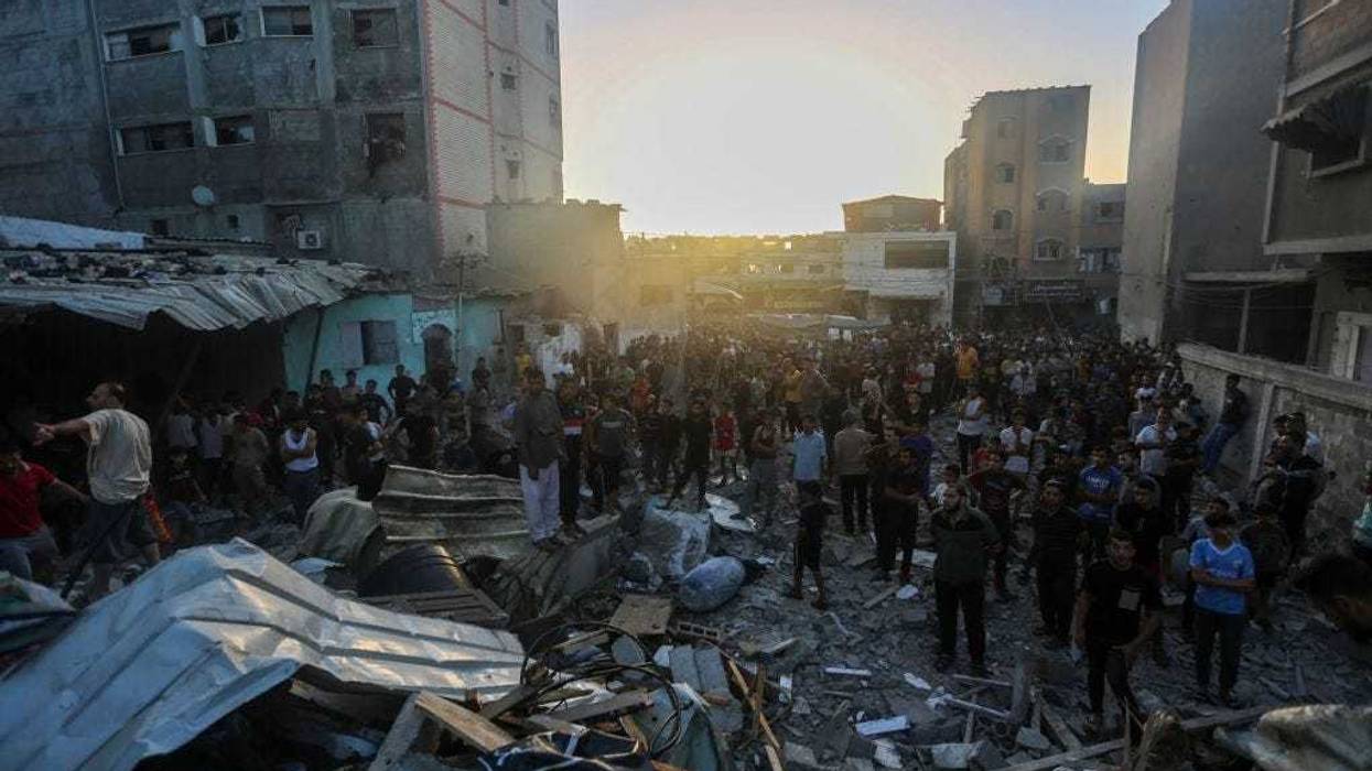 People search through buildings that were destroyed during Israeli air raids in the southern Gaza Strip November 4 2023 in Khan Yunis, Gaza. The Israeli army has expanded its military assault. The Gaza strip, a besieged Palestinian territory, is under heavy bombing from Israel in response to the large-scale attack carried out on October 7 by Hamas in Israel. The international community is stepping up pressure for a humanitarian truce.(Photo by Ahmad Hasaballah/Getty Images)