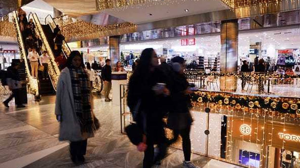 People shop at a mall decorated with holiday lights in Manhattan on December 18, 2025 in New York City. The Labor Department reported Thursday that inflation unexpectedly slowed in November, with the consumer price index rising 2.7% in November from a year earlier. (Photo by Spencer Platt/Getty Images)