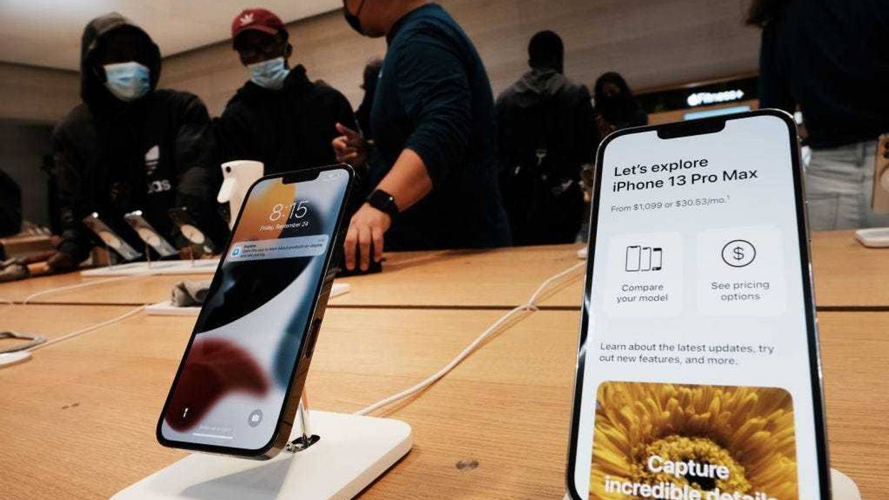 People shop at the Fifth Avenue Apple Store during the launch of Apple’s new iPhone 13 and iPhone 13 Mini on September 24, 2021 in New York City. The new phones come equipped with a A15 Bionic chip, improved dual-camera system and longer battery life than the iPhone 12. The iPhone 13 Mini starts at $729, and the iPhone 13 starts at $829. (Photo by Spencer Platt/Getty Images)