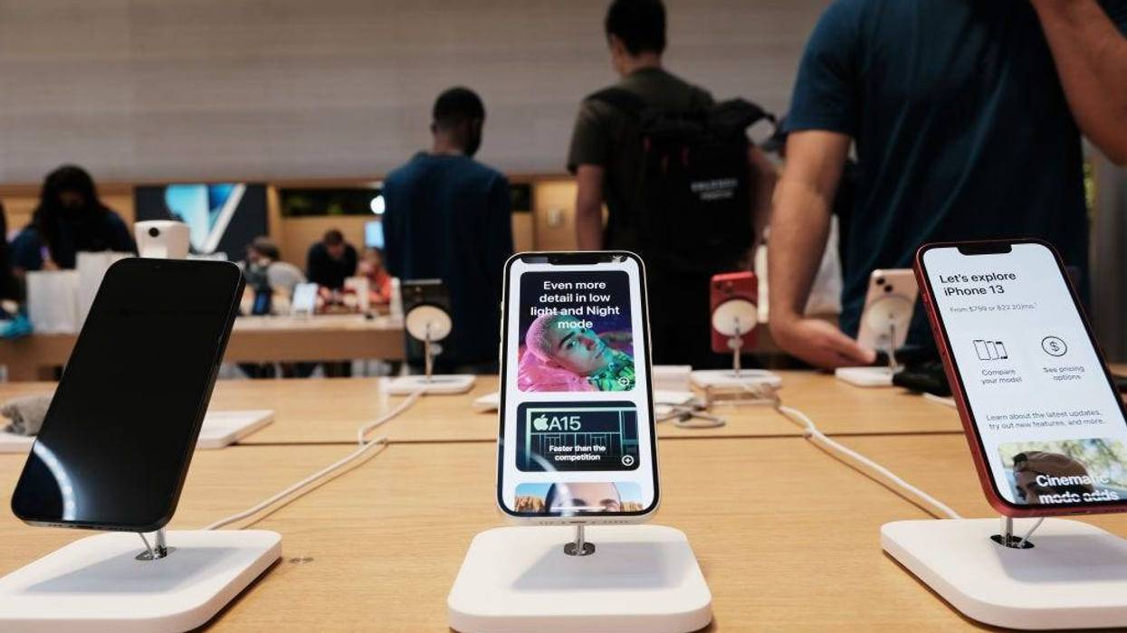 People shop at the Fifth Avenue Apple Store during the launch of Apple’s new iPhone 13 and iPhone 13 Mini on September 24, 2021 in New York City. The new phones come equipped with a A15 Bionic chip, improved dual-camera system and longer battery life than the iPhone 12. The iPhone 13 Mini starts at $729, and the iPhone 13 starts at $829. (Photo by Spencer Platt/Getty Images)