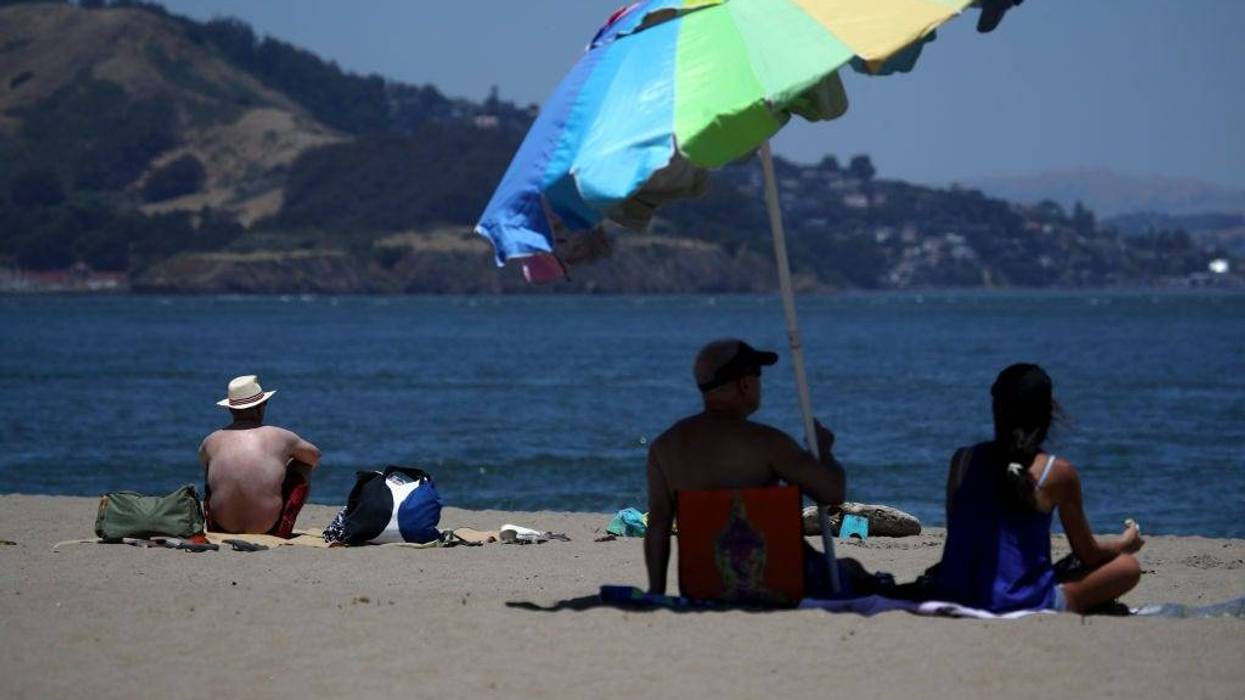 People sit on the beach at Crissy Field East Beach on June 11, 2019 in San Francisco, California.