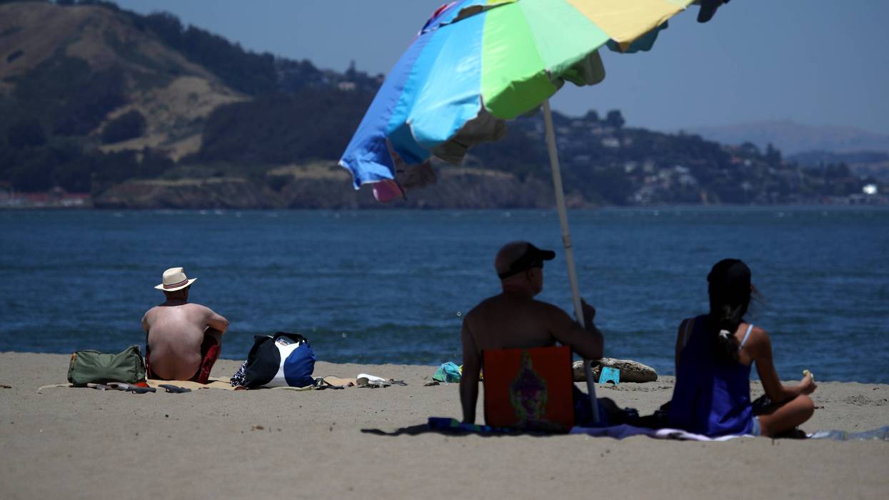 People sit on the beach at Crissy Field, June 2019