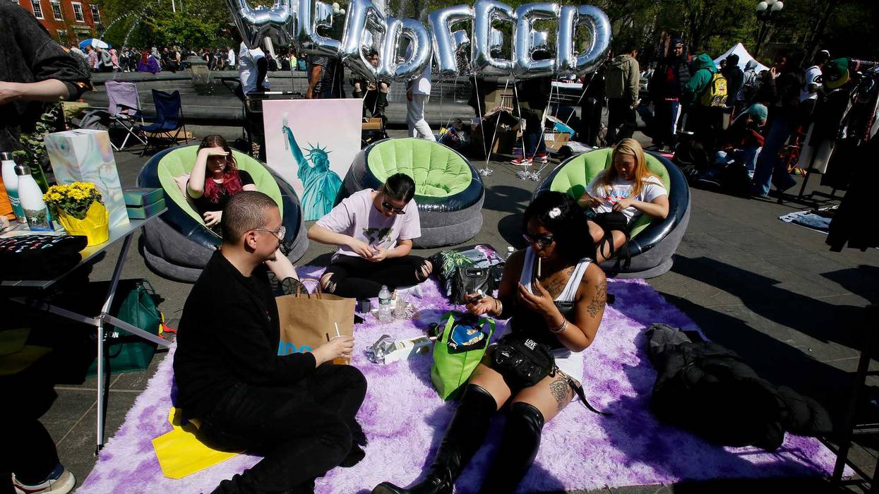 People smoke cannabis at Washington Square Park on April 20, 2023