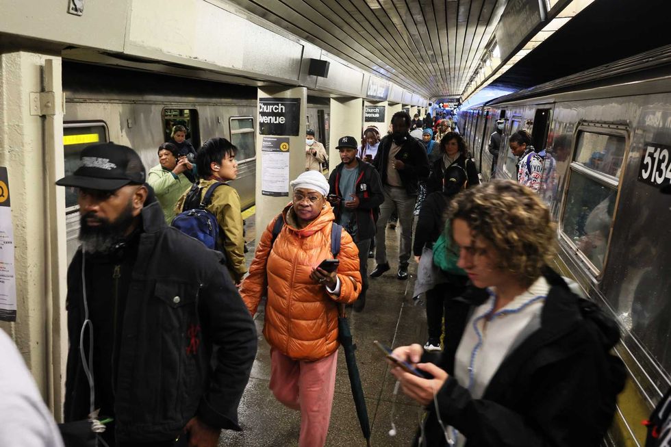 People stand around at the Church Avenue subway station as subway service is stopped amid heavy rain on September 29, 2023 in the Flatbush neighborhood of Brooklyn