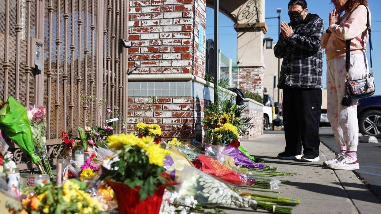 People stand at a makeshift memorial outside the scene of a deadly mass shooting at a ballroom dance studio on January 23, 2023 in Monterey Park, California.