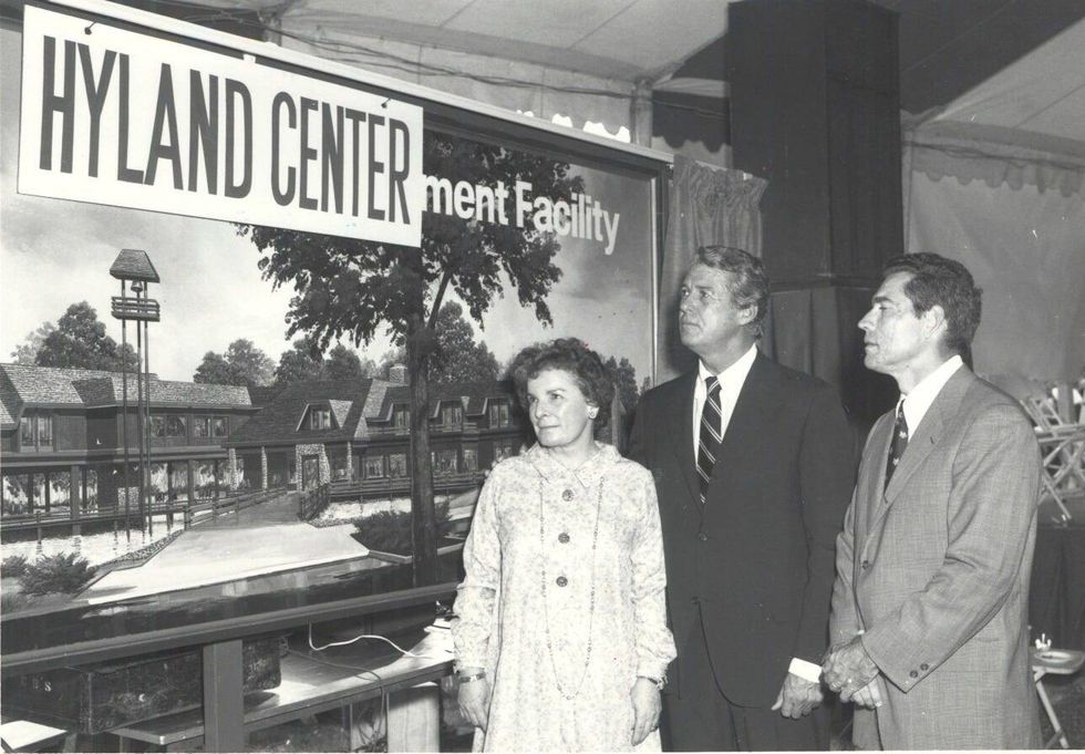 People stand in front of the Robert Hyland Center