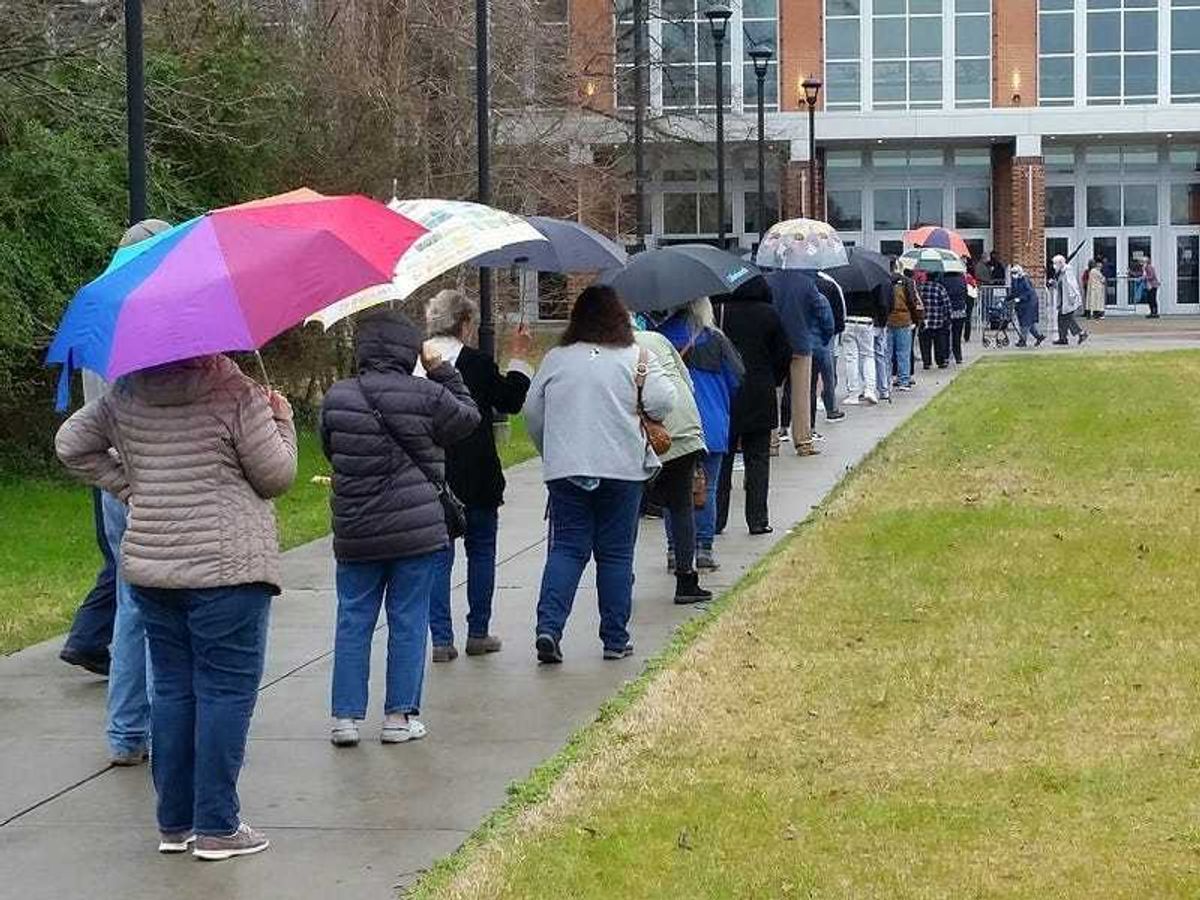 People stand in line for vaccines at Virginia State University