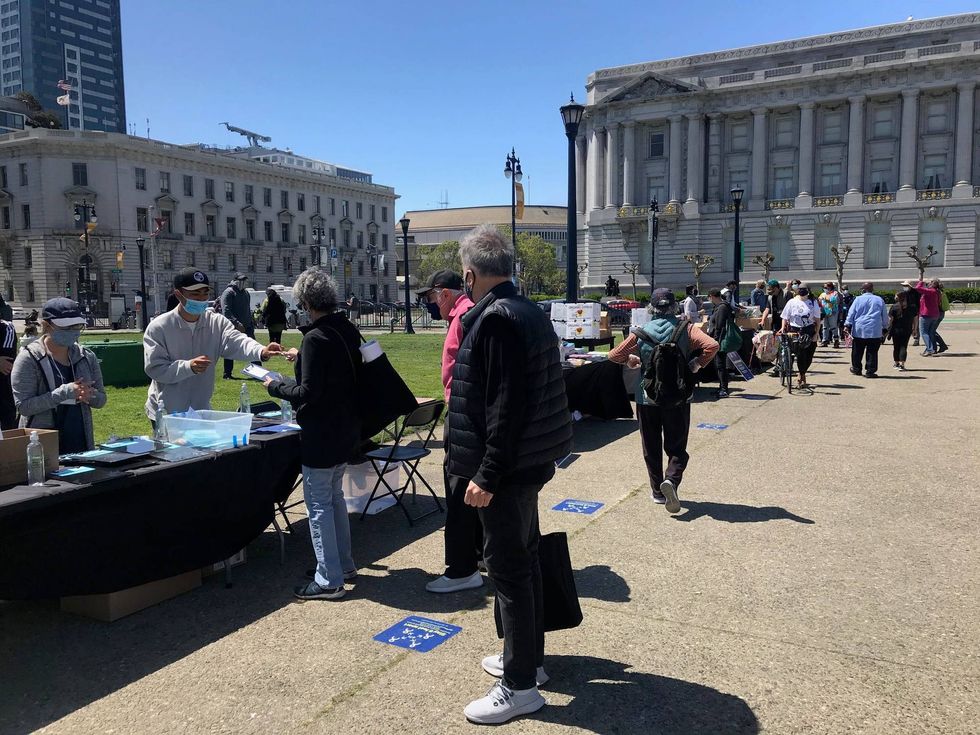 People stand in line to receive Campaign for Solidarity resources in San Francisco.
