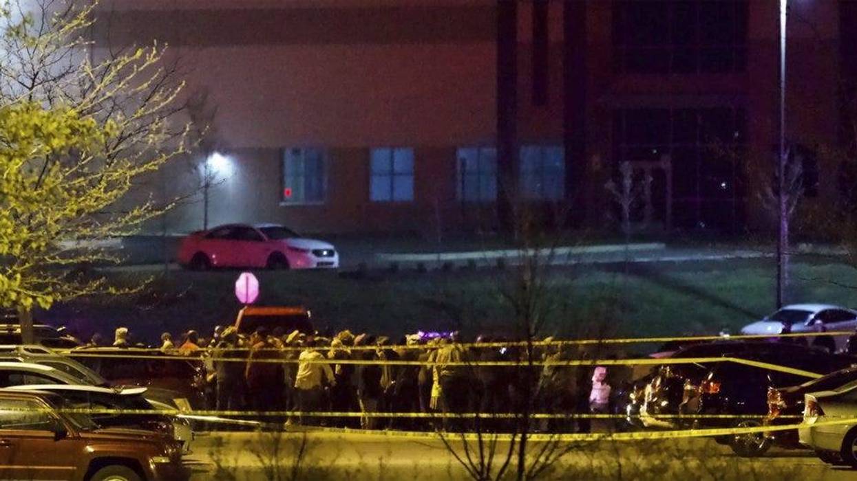 People stand outside a FedEx facility near Indianapolis International Airport after a shooting with multiple victims was reported late Thursday night, April 15, 2021.