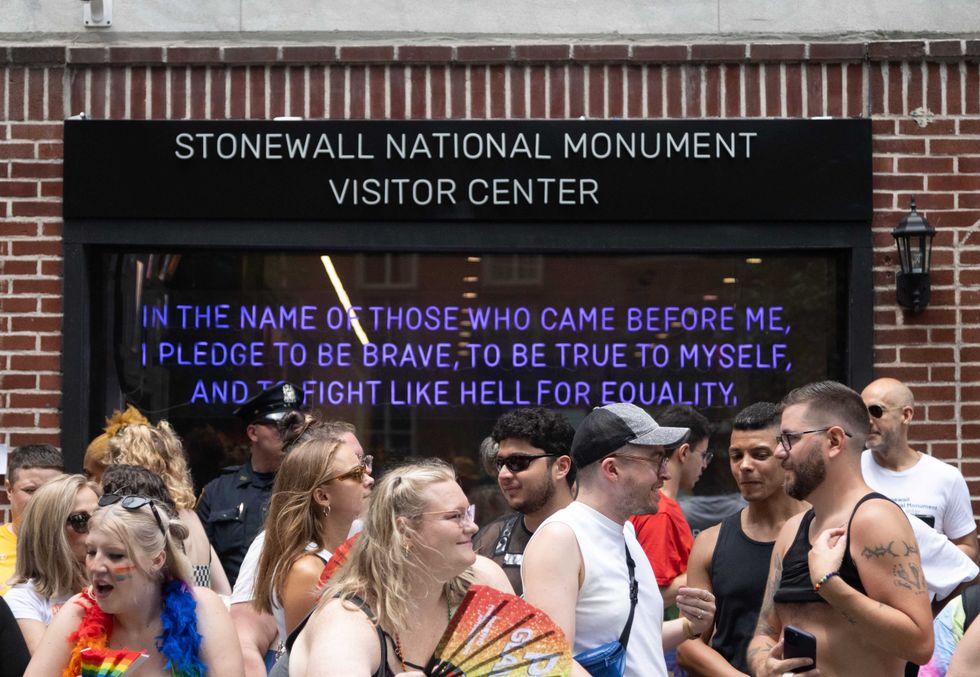 People stand outside Stonewall National Monument Visitor Center during the 2024 NYC Pride March on June 30, 2024.