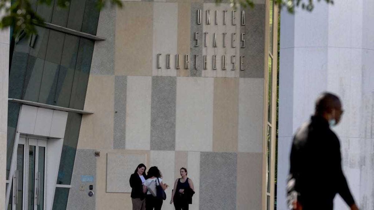 People stand outside the Wilkie D. Ferguson Jr. U.S. Courthouse entrance on January 04, 2022 in Miami, Florida.