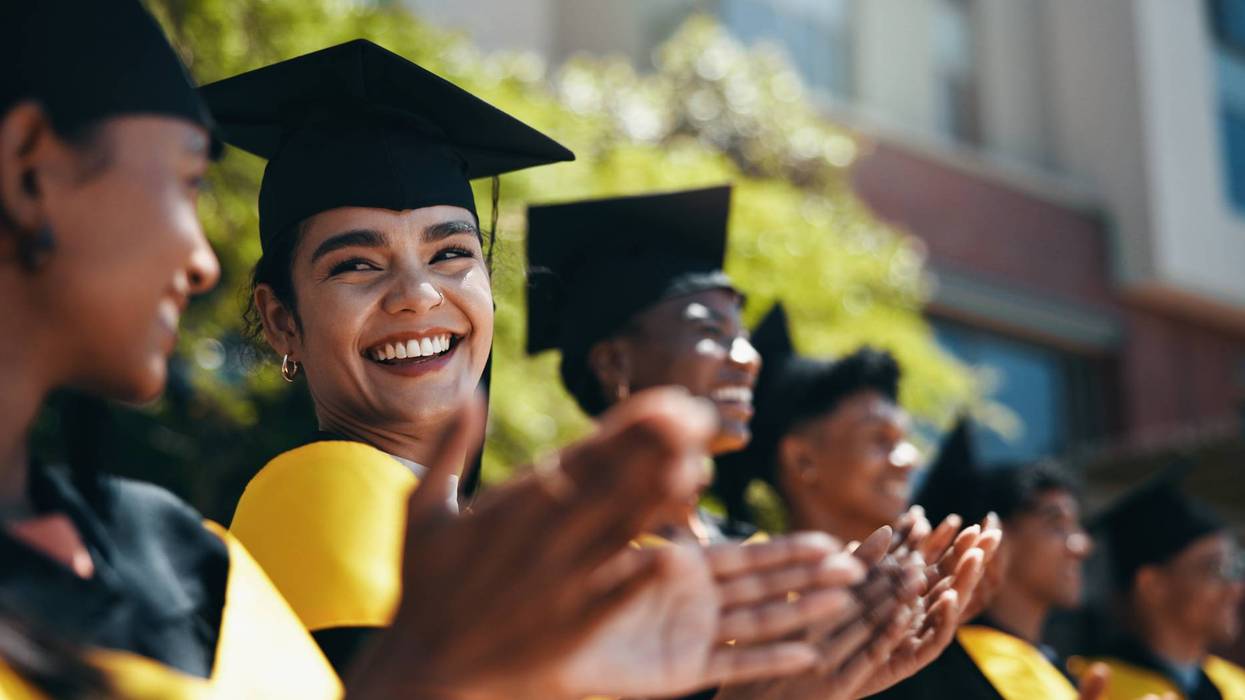 People, students and applause at university for graduation, peer support and happy for achievement. Class, clapping and outdoor on campus for academic success, pride and smile for education milestone