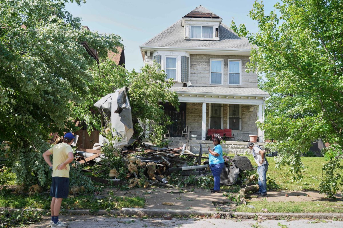 People survey damage after a severe storm moved through Friday, May 16, 2025, in St. Louis.