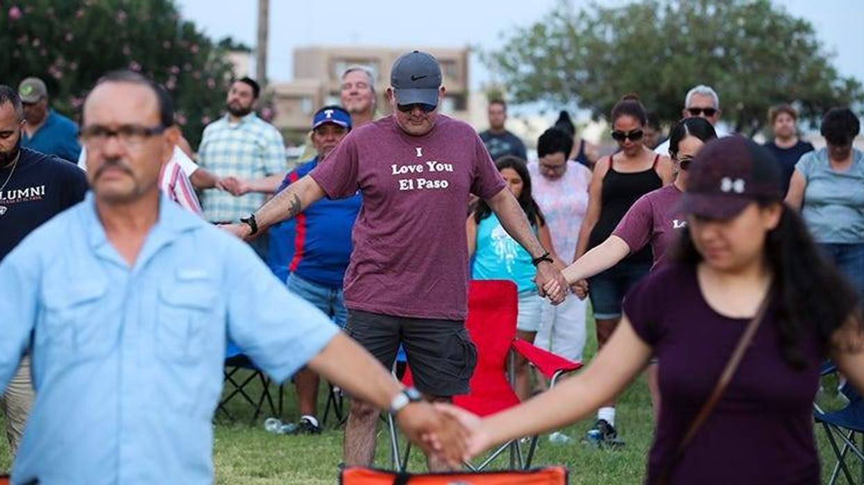 People take part in a prayer and vigil at Ponder Park in El Paso, Texas,