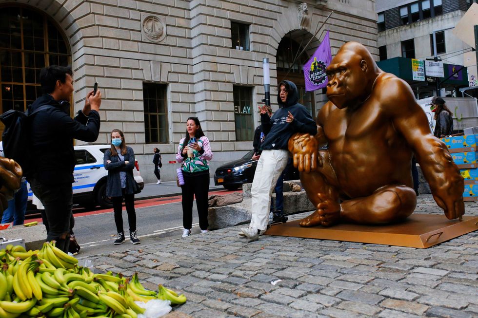 People take photos with the statue of Harambe on October 18, 2021 in New York City
