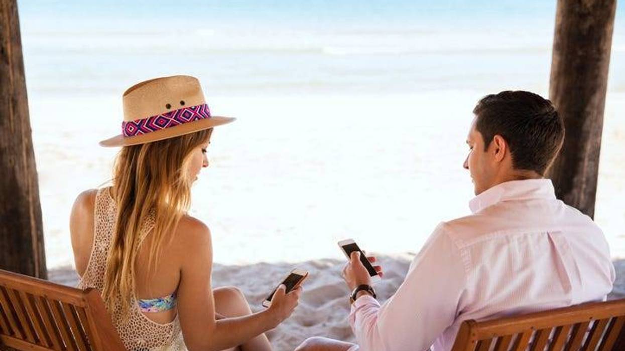 People texting while on vacation at the beach