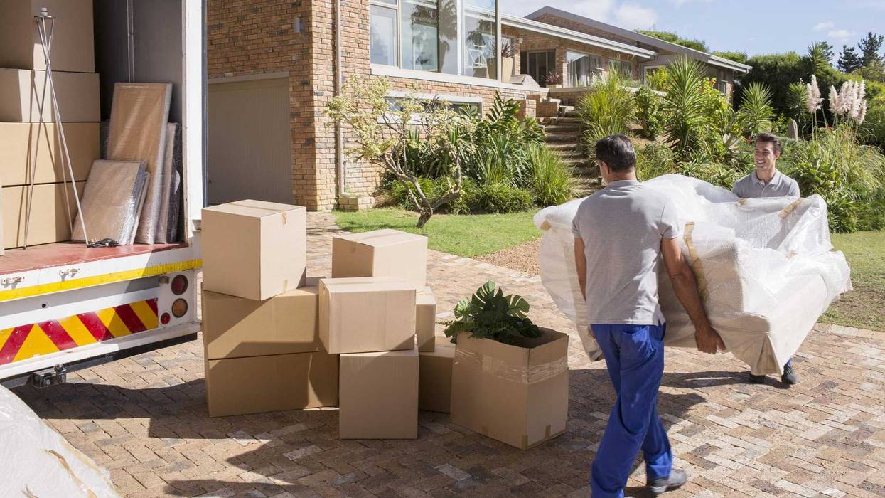 People unloading items off a moving truck