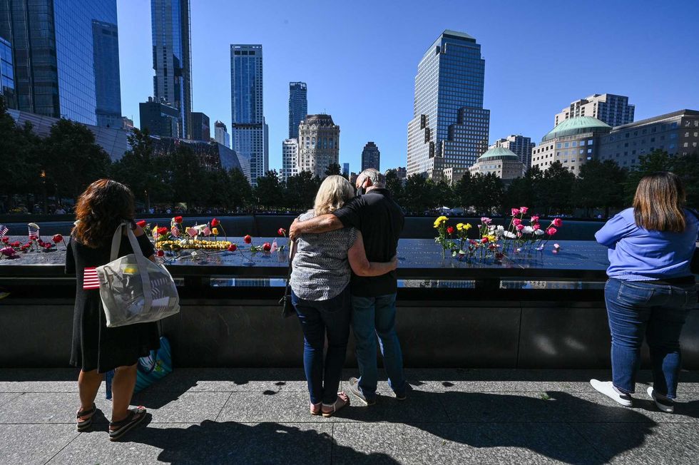 People view the memorial during a ceremony at the National September 11 Memorial & Museum commemorating the 20th anniversary of the September 11th terrorist attacks on the World Trade Center on September 11, 2021 in New York City