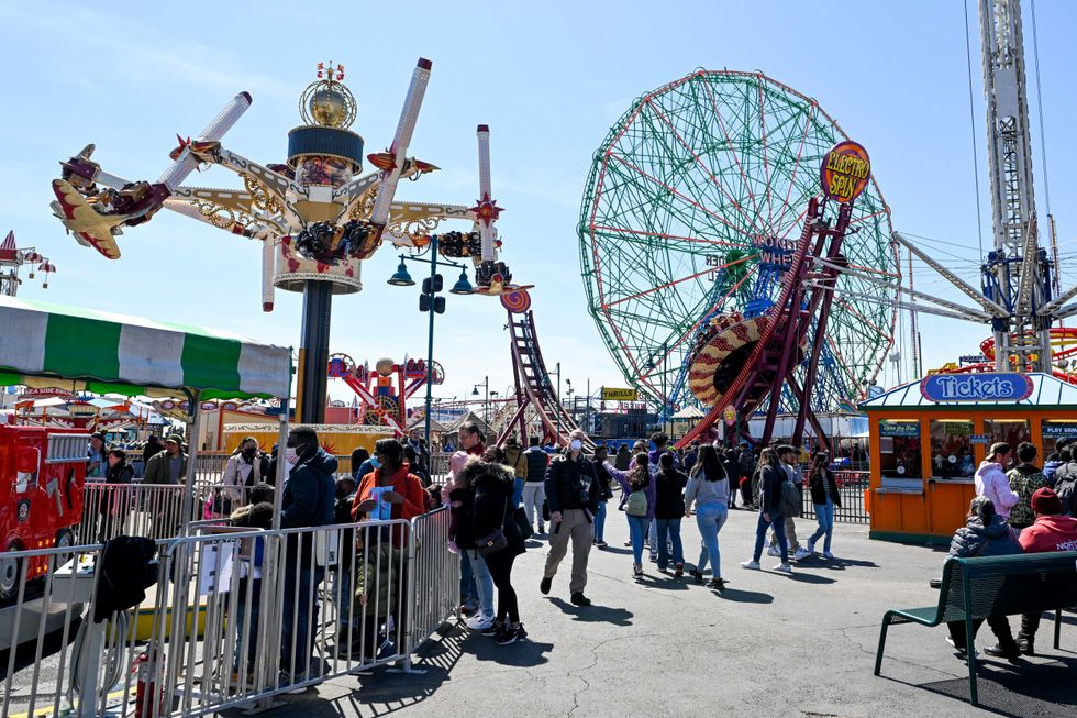People visit Luna Park on the opening day of the season at Coney Island.