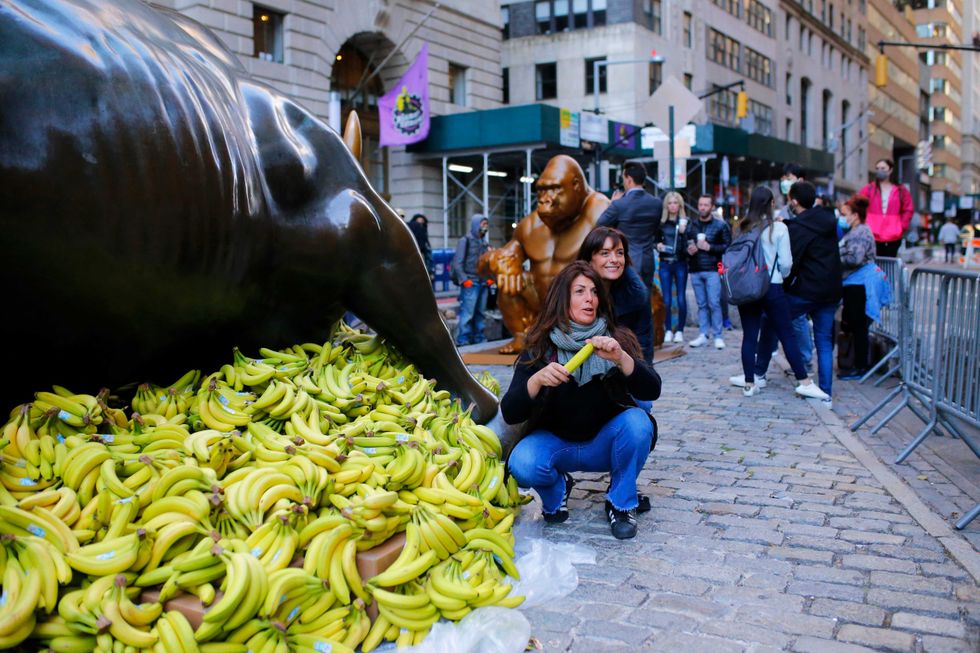 People visit the Harambe and Charging Bull statues on October 18, 2021 in New York City