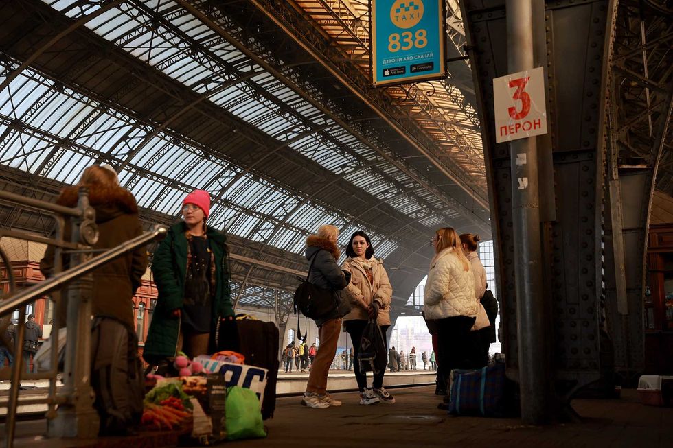 People wait for a train at the main train station on March 23, 2022 in Lviv, Ukraine