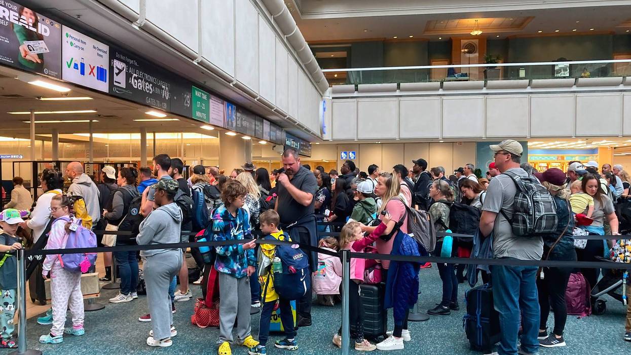 People wait in a TSA screening line at Orlando International Airport three days before Thanksgiving in Orlando, Florida, in 2022.