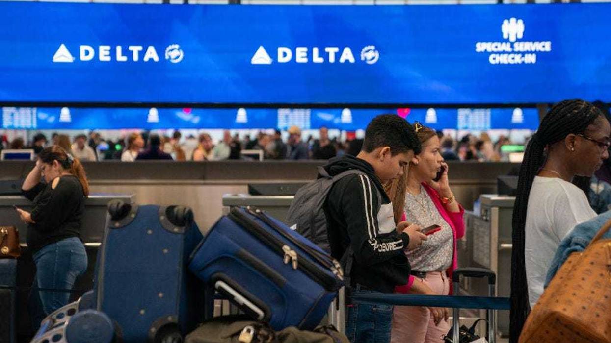 People wait in line at the Delta Airlines checkin counter of JFK International airport on June 30, 2023 in New York City.
