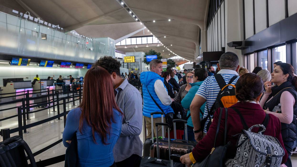 People wait in line for a delayed flight at Newark airport on May 5.