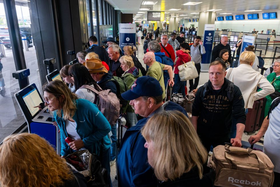 People wait in line for a delayed flight at Newark Liberty International Airport on May 5, 2025, in Newark, New Jersey.