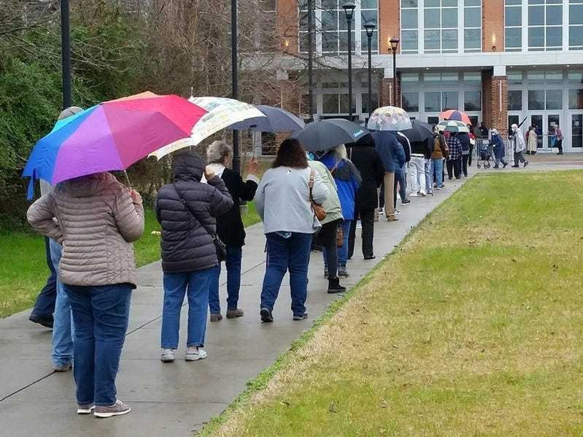 People wait in line for Covid-19 vaccines at Virginia State University.